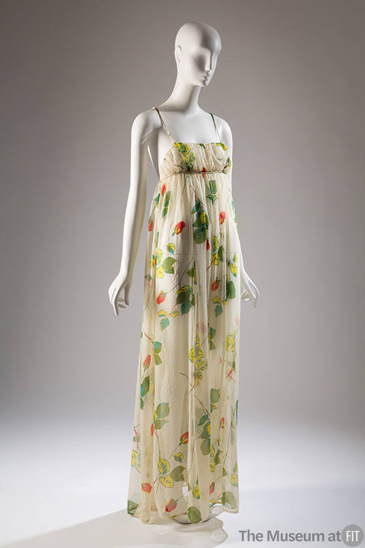 Summer evening dress in sheer white printed with design of long stem red roses