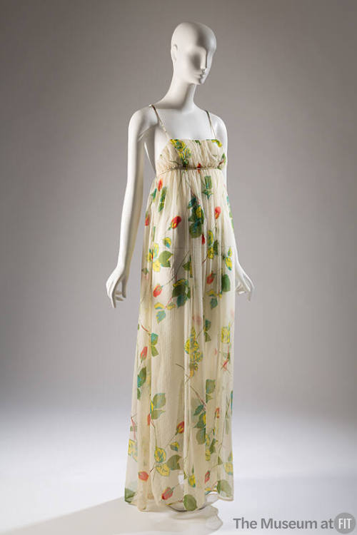 Summer evening dress in sheer white printed with design of long stem red roses