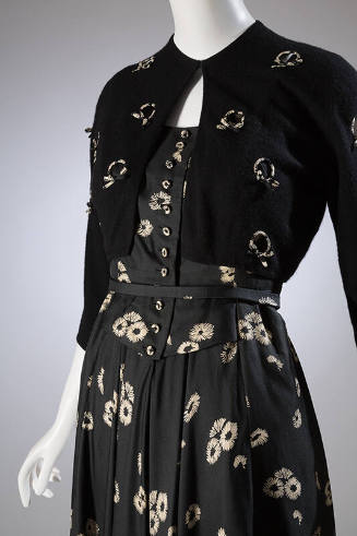 Black dress with cream floral print and button front bodice with black bolero embellished with …
