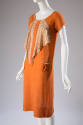 Orange short sleeve dress with triangular cascade of patterned orange and tan fabric from neckl…