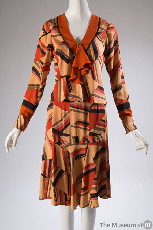 Two piece, retro 1920/30's styled dress with geometric print in beige, orange, black, and rose