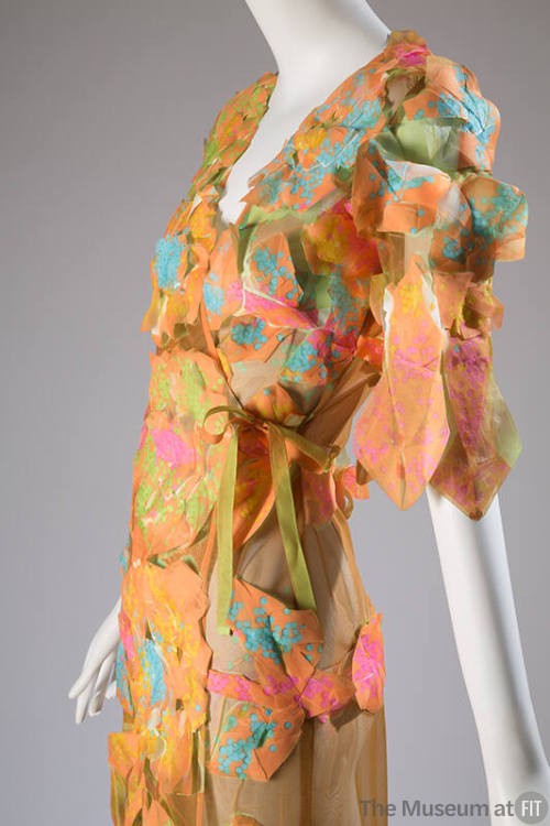 Detail of orange, pink and green sheer pieced rosette dress with side ribbon tie