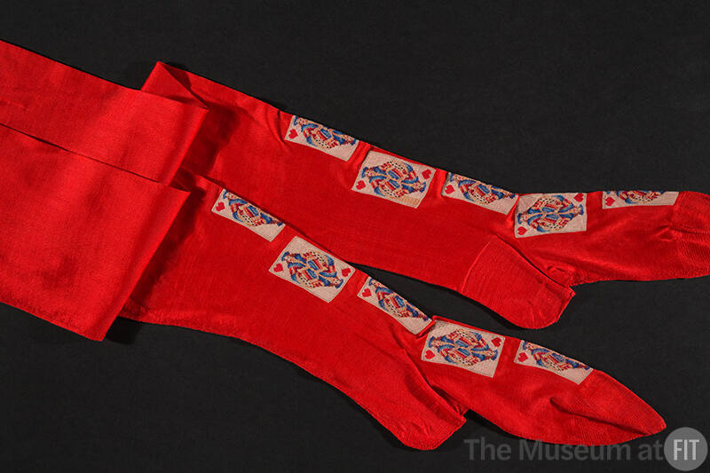 Pair of red stockings with playing cards embroidered down front