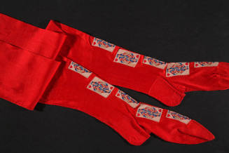 Pair of red stockings with playing cards embroidered down front