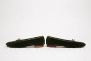 Side view of dark green velvet ballet flats shown heel to heel