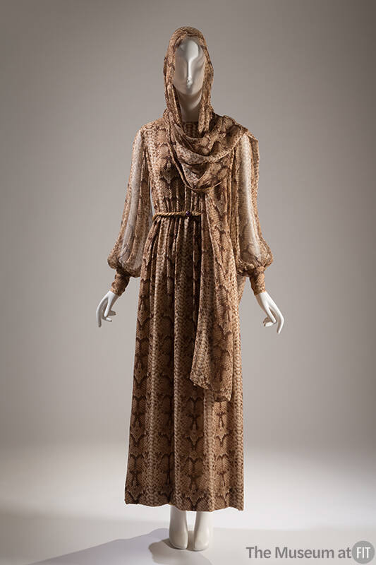 Ankle length dress in brown reptile print with long sleeves cinched at wrist and matching stole…