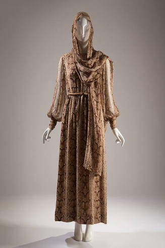 Ankle length dress in brown reptile print with long sleeves cinched at wrist and matching stole…