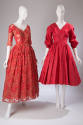 Two-piece red floral lace floor length dress and red dress with sleeves gathered at elbows and …