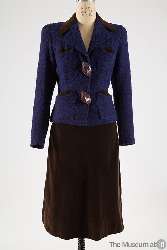 Purple and black tweed suit jacket with brown leather buttons and brown skirt