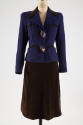 Purple and black tweed suit jacket with brown leather buttons and brown skirt