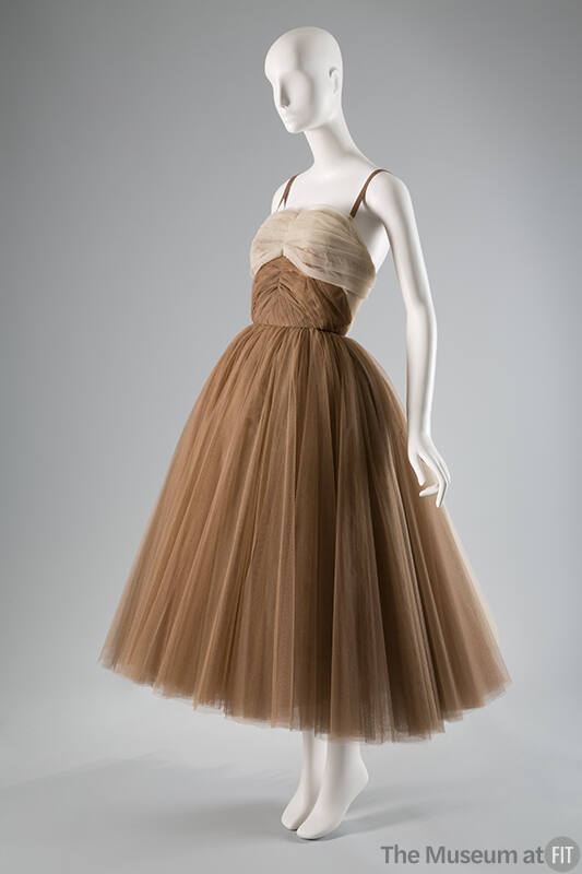 Tan calf-length evening gown with beige bodice trim, thin shoulder straps and full tutu style s…