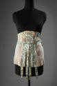Blue/green girdle with gold brocade floral and ribbon motifs, elastic panels on either side and…