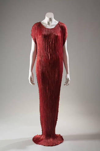 Red pleated silk teagown trimmed with yellow beads, floor length that slightly pools, sleeveles…