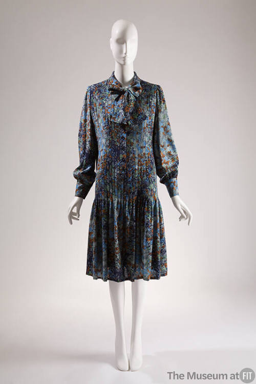 Blue, navy, orange and green floral printed long sleeve to-the-knee dress with pleated front an…
