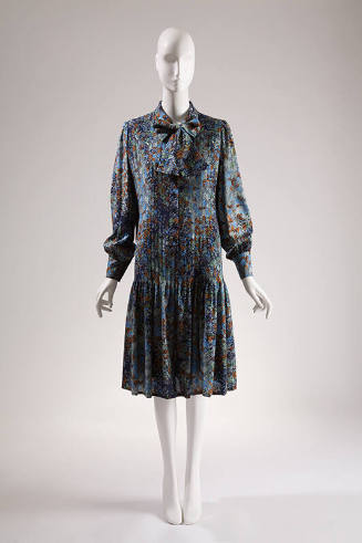 Blue, navy, orange and green floral printed long sleeve to-the-knee dress with pleated front an…