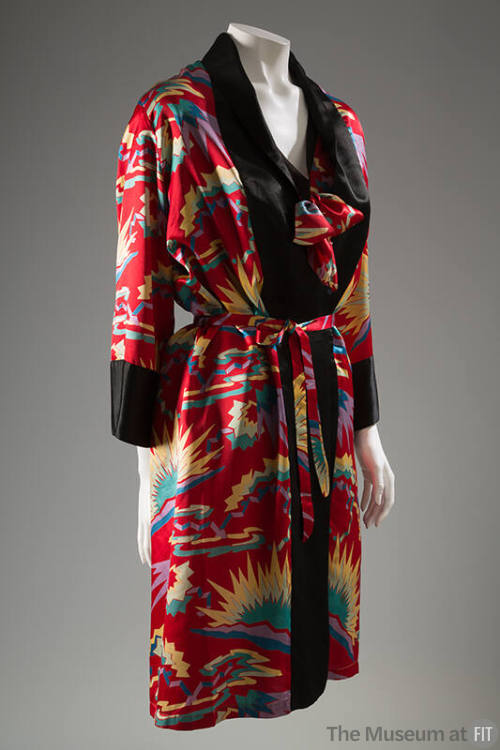 Red robe wirh yellow, purple and green sunburst design, bow and belt, black trim and cuffs