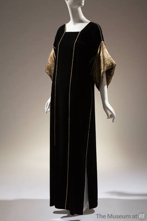 Black velvet square neck floor length dress with gold lamé turn back sleeves and gold trim
