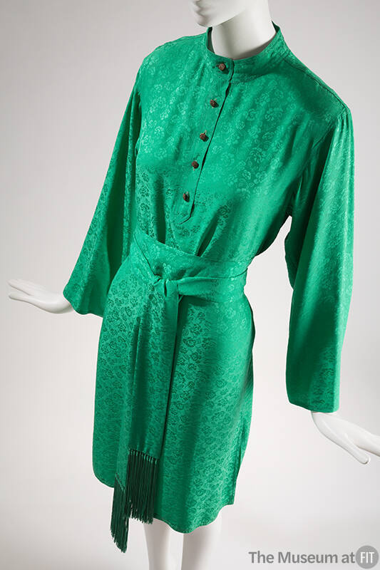 Green knee length dress with woven floral design, long sleeves, button front bodice and matchin…