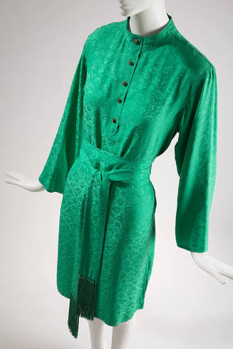 Green knee length dress with woven floral design, long sleeves, button front bodice and matchin…