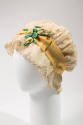 White net night cap with embroidery, yellow ribbon, and green flowers