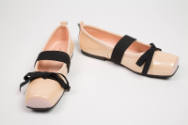 Pale pink square toe ballet flats with black bow and wide instep strap extended to sole