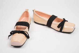 Pale pink square toe ballet flats with black bow and wide instep strap extended to sole