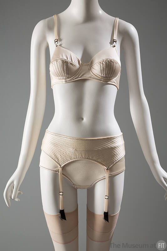 Off-white bra, garter belt and panties with black stitching 