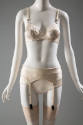 Off-white bra, garter belt and panties with black stitching 