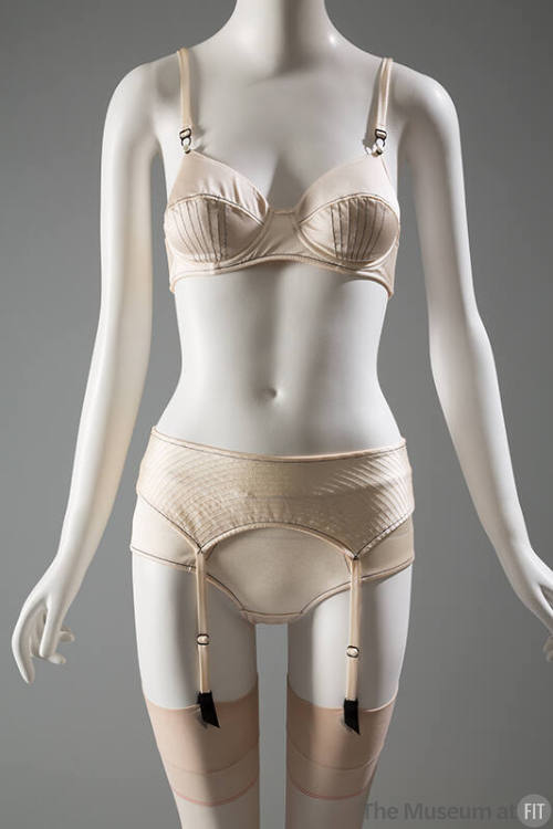 Off-white bra, garter belt and panties with black stitching 
