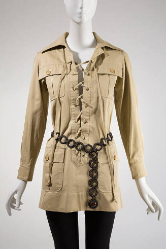 Bronze flat ring belt with raised dots styled over tan button down jacket and black leggings