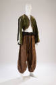 moss green bolero with slit at long sleeves styled with brown harem pants