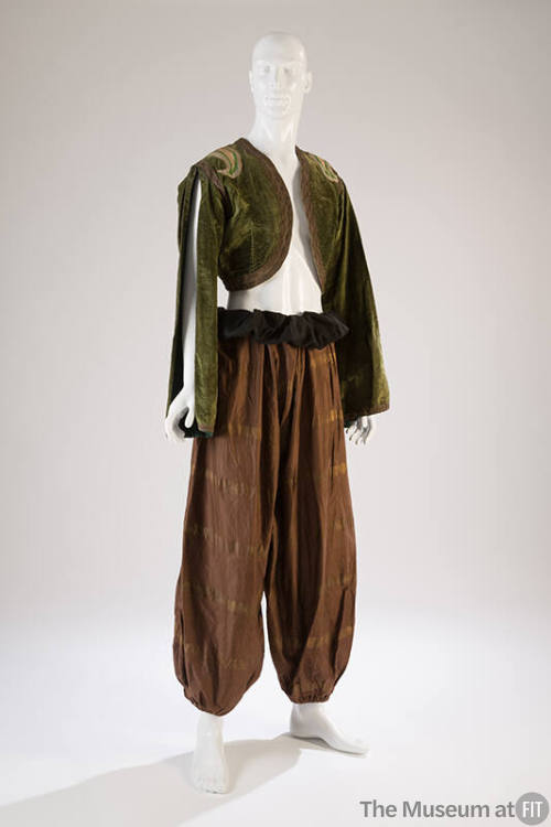 moss green bolero with slit at long sleeves styled with brown harem pants