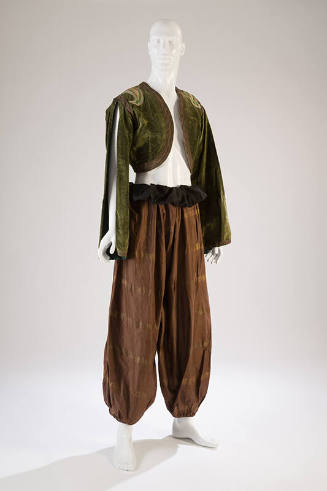 moss green bolero with slit at long sleeves styled with brown harem pants