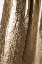 Detail view of off-white underskirt showing floral motif quilting