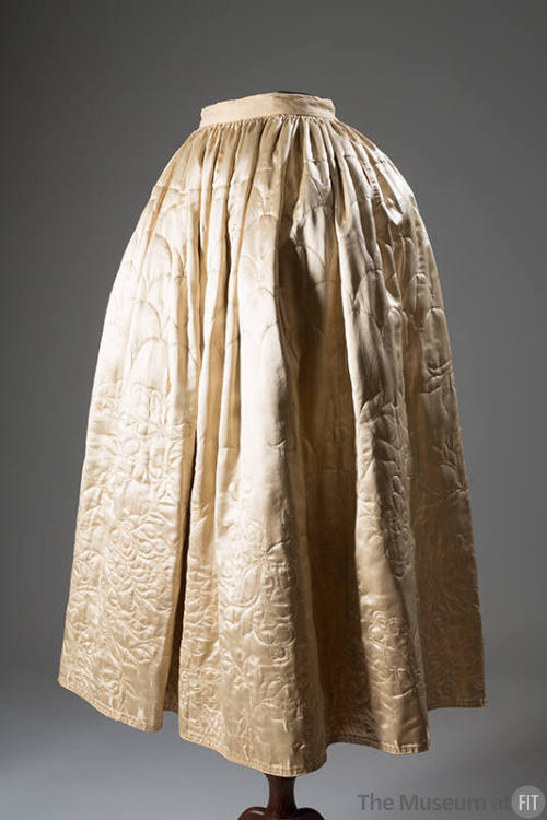 Off-white silk satin floor length underskirt quilted in scallops at top and floral motif around…