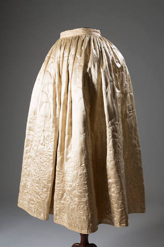 Off-white silk satin floor length underskirt quilted in scallops at top and floral motif around…