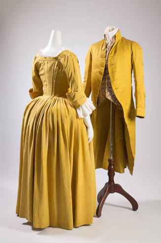 Yellow/green dress shown from the back with bustle skirt on left and man’s cutaway jacket in sa…