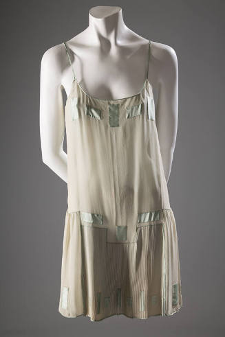 Pale green camiknickers with green satin spaghetti straps and rectangular insets at bust, along…