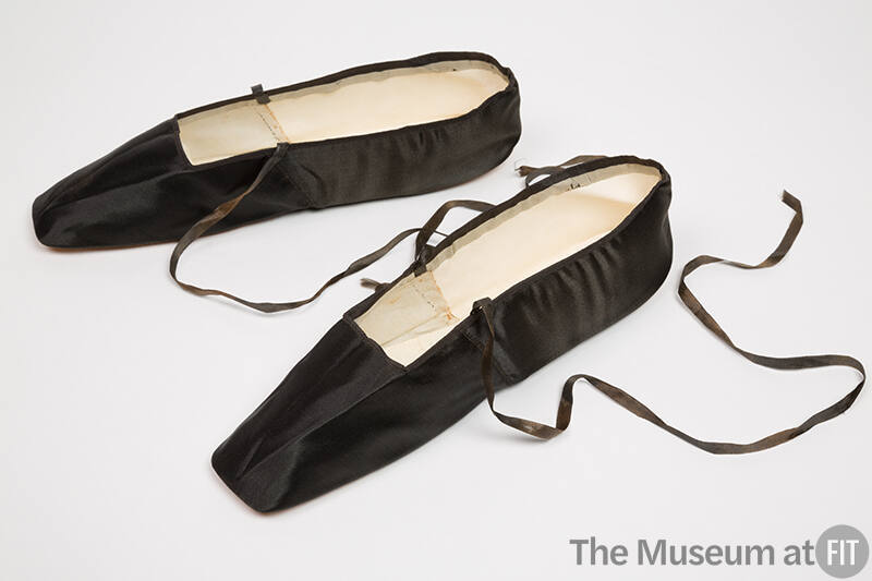 Pair of black flat slippers with square toe and thin ribbon ankle ties