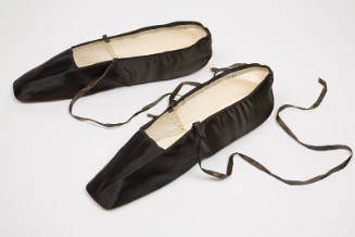 Pair of black flat slippers with square toe and thin ribbon ankle ties