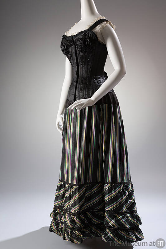 Black floor length underskirt with green, yellow, and purple vertical stripes styled with black…