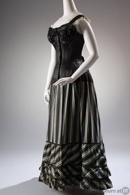 Black floor length underskirt with green, yellow, and purple vertical stripes styled with black…