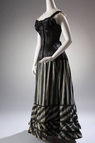 Black floor length underskirt with green, yellow, and purple vertical stripes styled with black…