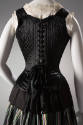 Back view of black corset top with straps and self tie bow