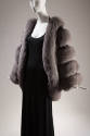 Detail of grey fox fur long sleeve jacket over a black dress