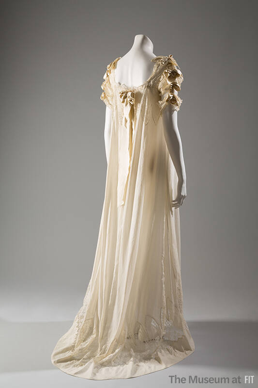 off-white night gown with satin bows, short lace sleeves, and ribbon on upper back