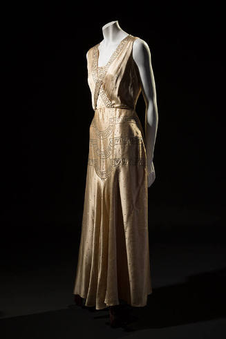 Ivory silk satin sleeveless floor length evening dress with Art Deco border design crossed acro…