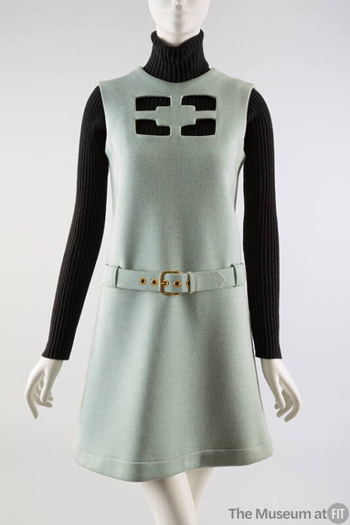 Aqua knee length dress with geometric cut out on chest & belt, styled with black longsleeve tur…