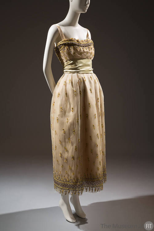 Cream net evening dress embroidered with yellow flowers, gilt sequins, and crystal beads