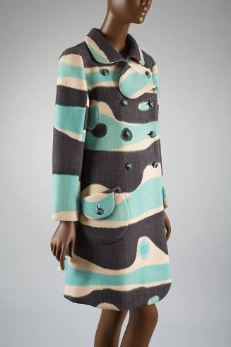 Double breasted coat printed in horizontal irregularly curved blue, grey, and white bands; coll…